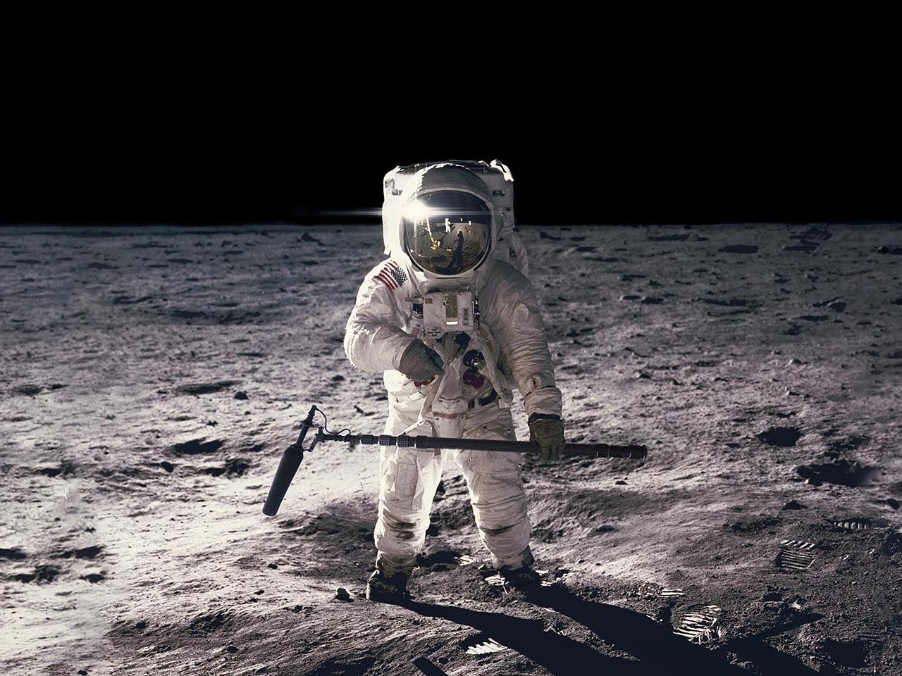 Astronaut on rock surface with space background. Elements of this image furnished by NASA